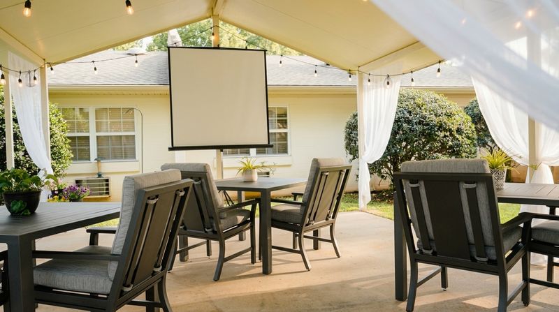 Covered outdoor patio with seating and string lights