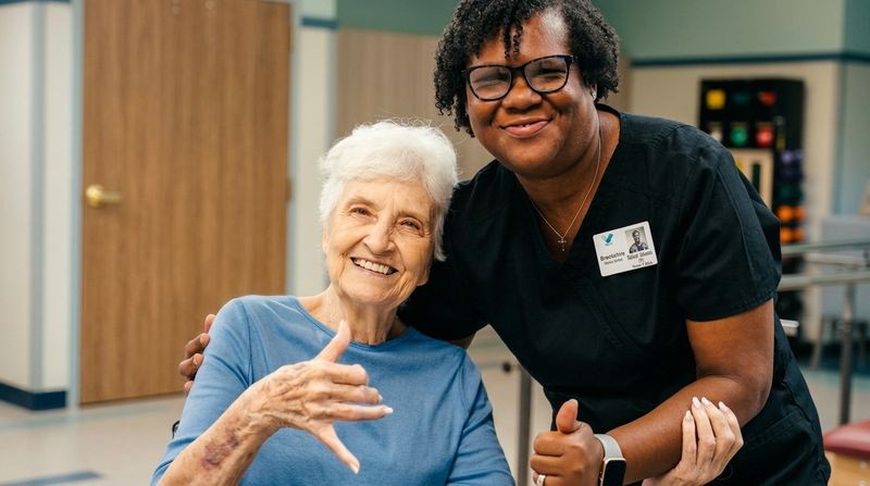 A resident and a Brookshire nurse sharing a smile